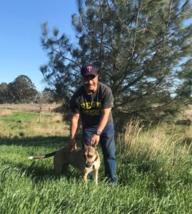 Paul with his dog near his manmade pond. He builds healthy soil across the state by training farmers.