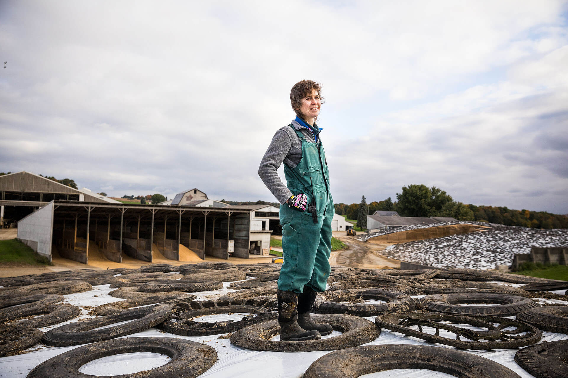 Meghan Hauser of Table Rock Farm stands on covered silage feed.