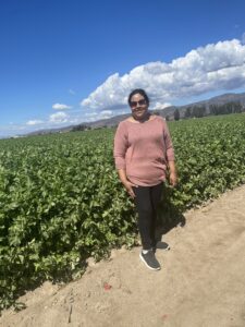 Anel stands in the small scale farm fields at ALBA near Salinas, California.