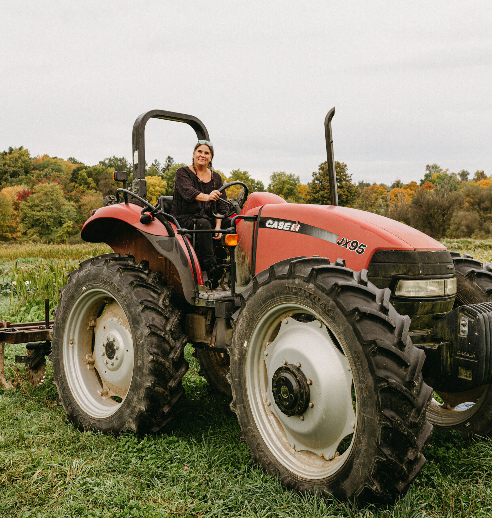 Claudia atop her tractor at Little Seed Gardens. Photo provided by Claudia Kenny.